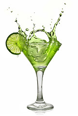 Image showing Green alcohol cocktail with splash and green lime isolated on wh