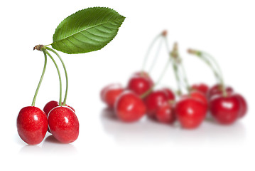 Image showing red cherry with leaves isolated on white