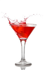 Image showing Red cocktail with splash isolated on white