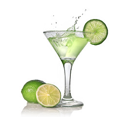 Image showing Green alcohol cocktail with splash and green lime isolated on wh