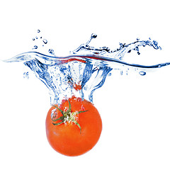 Image showing red tomato dropped into water isolated on white