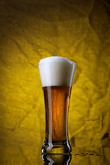 Image showing Beer in glass  on yellow background