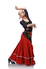 Image showing young woman dancing flamenco with castanets isolated on white