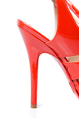 Image showing heel of red leather female shoe isolated on white