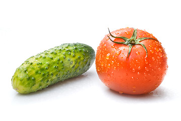 Image showing red tomato and green cucumber with water drops isolated on white