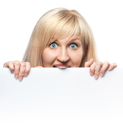 Image showing hungry young woman holding white empty paper isolated on white