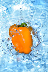 Image showing Yellow pepper dropped into water with bubbles isolated on white