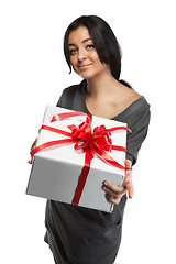 Image showing Young smiling woman holding gift isolated on white