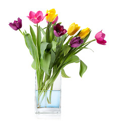 Image showing bouquet from tulips in glass vase isolated on white