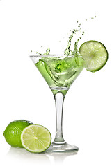 Image showing Green alchohol cocktail with splash and green lime isolated on w