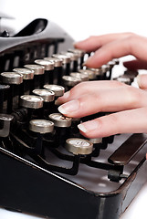 Image showing fingers on vintage typing machine on white