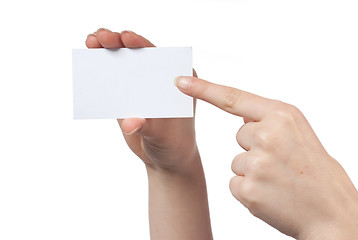 Image showing Woman hand holding empty visiting card and pointing on it isolat