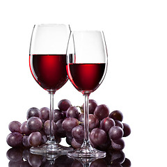 Image showing Red wine in glasses with grape isolated on white
