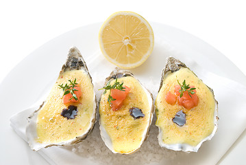 Image showing oysters with sauce and lemon