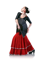 Image showing young woman dancing flamenco with fan isolated on white