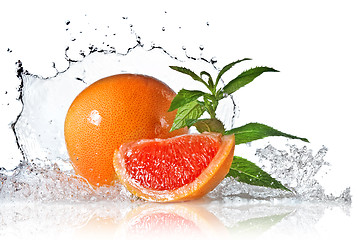 Image showing Water splash on grapefruit with mint isolated on white