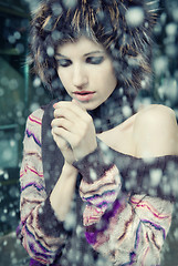 Image showing young woman freeze under falling snow