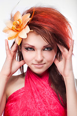 Image showing Portrait of beautiful woman with flower in hair on white