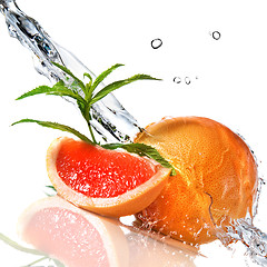 Image showing Water splash on grapefruit with mint isolated on white