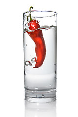 Image showing red pepper dropped into water glass with bubbles