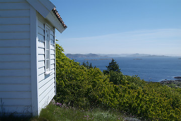 Image showing Small, white cabin with seaview