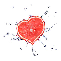 Image showing heart from grapefruit dropped into water with splash isolated on