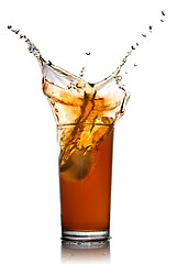 Image showing Beautiful splash of cola in glass isolated on white