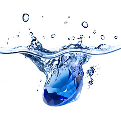 Image showing blue gem falling into water with splash isolated on white