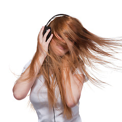 Image showing Woman with headphones and hair in motion on white
