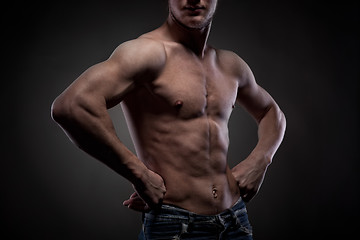 Image showing Muscular naked man on black