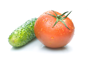 Image showing red tomato and green cucumber with water drops isolated on white