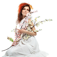 Image showing Portrait of beautiful woman with spring flowers on white