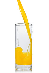 Image showing orange juice poring into glass isolated on white