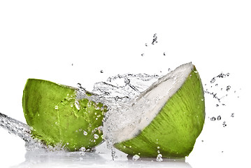 Image showing Green coconut with water splash isolated on white