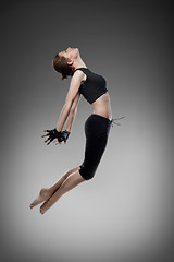 Image showing jumping young dancer on black