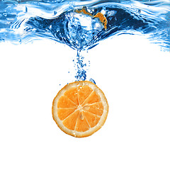 Image showing Fresh orange dropped into water with bubbles isolated on white