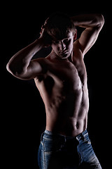 Image showing Posing muscular naked man on black