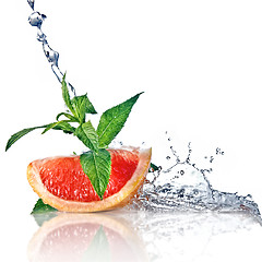 Image showing Water splash on grapefruit with mint isolated on white