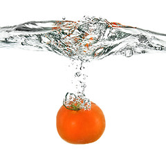 Image showing red tomato dropped into water isolated on white