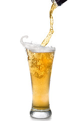 Image showing Beer pouring from bottle into glass isolated on white