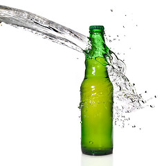 Image showing Green beer bottle with water splash isolated on white