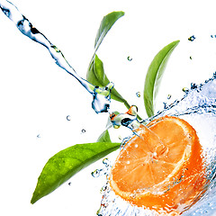 Image showing water drops on orange with green leaves isolated on white