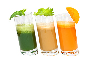 Image showing fresh juices from carrot, celery and parsley in glasses isolated