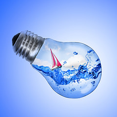 Image showing Energy concept. Light bulb with water and yacht inside isolated 