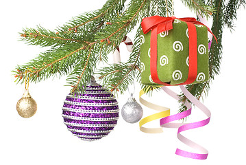 Image showing Christmas balls, gift and decoration on fir tree branch isolated