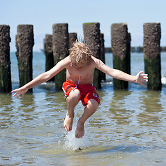 Image showing Boy jumps in sea