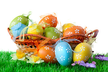 Image showing color easter eggs in basket isolated on white