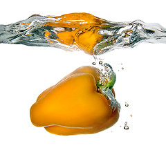 Image showing Yellow pepper dropped into water with bubbles isolated on white