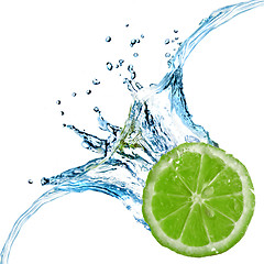 Image showing Fresh lime dropped into water with splash isolated on white