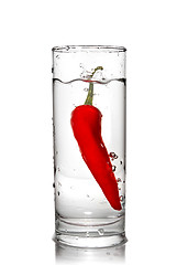 Image showing red pepper dropped into water glass with bubbles